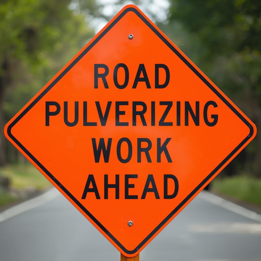 Sign stating that road pulverizing work ahead